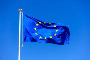 eu-flag-european-union-flag-on-a-pole-waving-on-bl-P5QSR3A